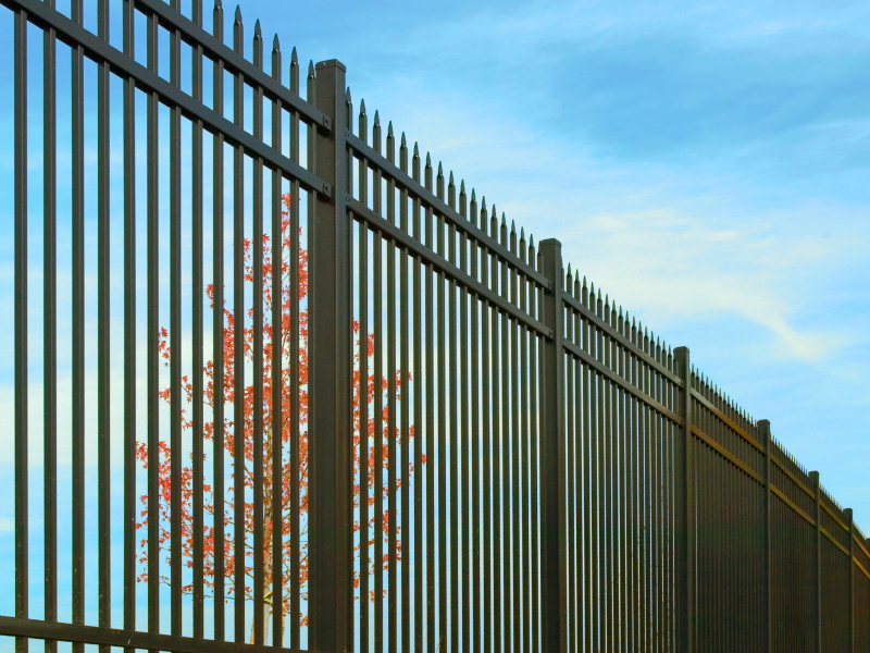 Tall black metal security fence with anti-climb spear-top pickets installed on a property in Cambridge, Ontario by King Fence.